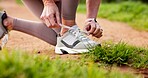 Fitness, hands and person tying laces in nature for running, workout or training for marathon. Shoes, outdoor and closeup of athlete preparing for cardio, sports or endurance exercise in park.