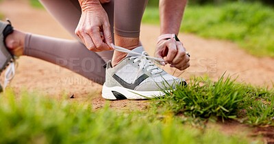 Buy stock photo Fitness, hands and person tying laces in nature for running, workout or training for marathon. Shoes, outdoor and closeup of athlete preparing for cardio, sports or endurance exercise in park.