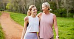 Mother, daughter and bonding in forest with hiking for fitness adventure, sightseeing or explore nature. Embrace, mature woman or girl in woods with walking, holiday travel or talking on outdoor path