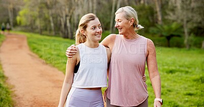 Buy stock photo Mother, daughter and bonding in forest with hiking for fitness adventure, sightseeing or explore nature. Embrace, mature woman or girl in woods with walking, holiday travel or talking on outdoor path