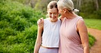 Mother, daughter or together in forest with hiking for fitness adventure, sightseeing or explore nature. Embrace, mature woman or girl in woods with walking, holiday travel or talking on outdoor path