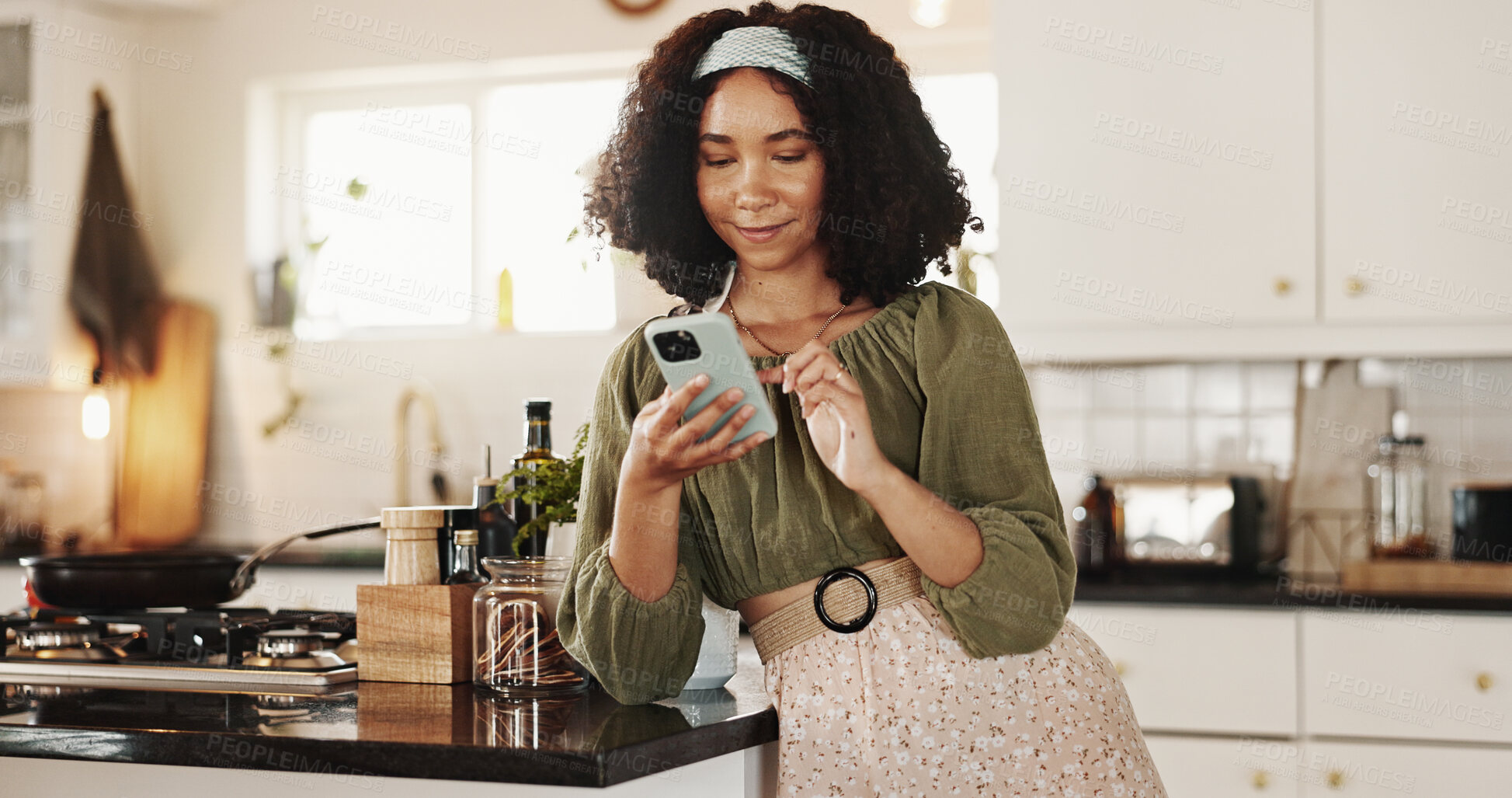 Buy stock photo Woman, reading and phone in kitchen for social media, text message and research recipe ideas. Girl, mobile and scroll on internet in home for connectivity, communication or smile for weekend planning