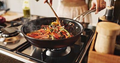 Buy stock photo Person, cooking and pan with stir fry on stove for food, meal prep or vegetables in kitchen at home. Closeup, spoon and wok with peppers and organic ingredients for taste, diet or lunch at house