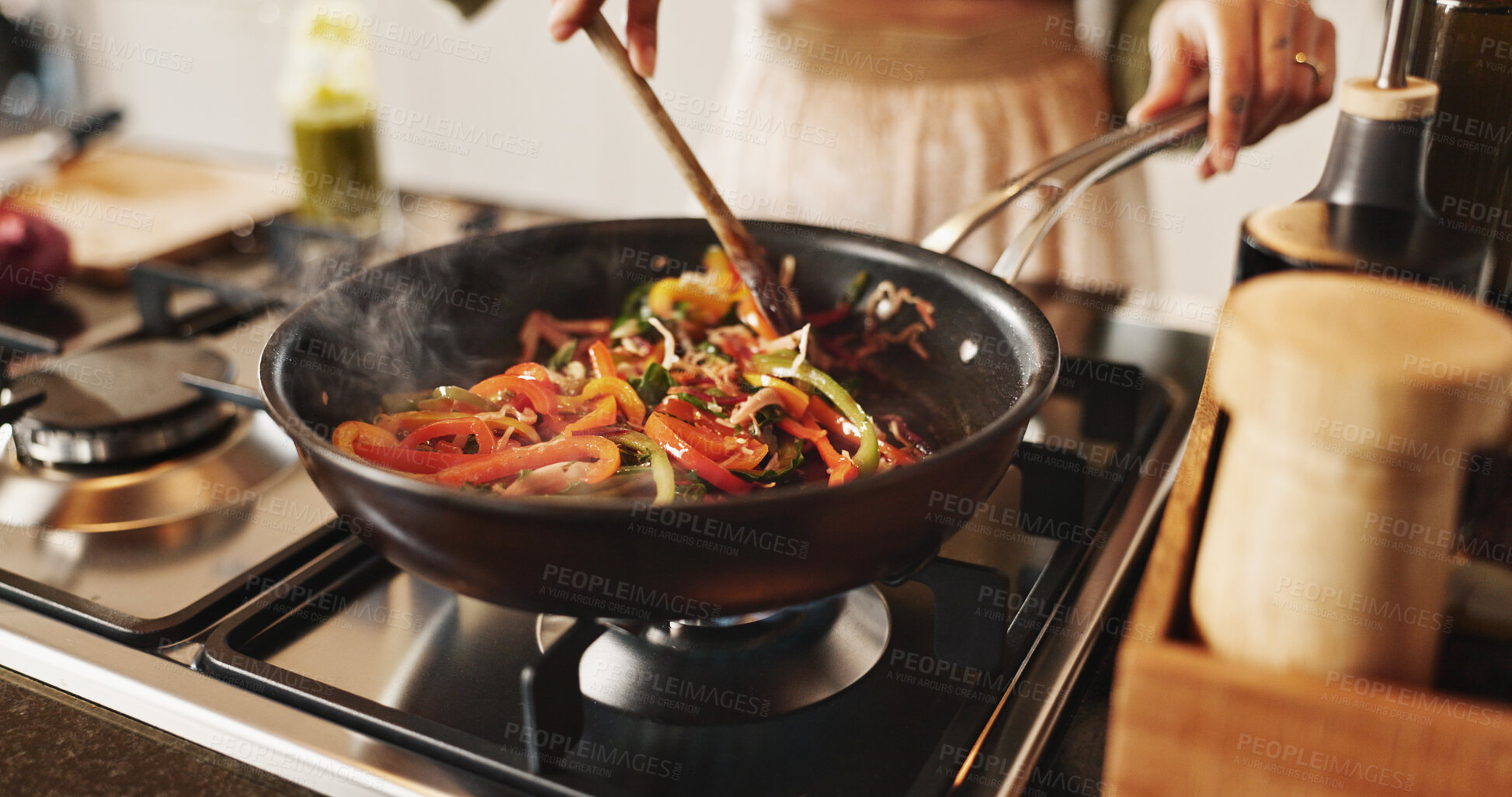 Buy stock photo Person, cooking and pan with stir fry on stove for food, meal prep or vegetables in kitchen at home. Closeup, spoon and wok with peppers and organic ingredients for taste, diet or lunch at house