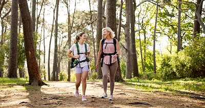 Buy stock photo Mother, daughter and walking in forest with laughing for fitness adventure, sightseeing and explore nature. Backpack, mature woman and girl in woods with hiking, holiday travel and bonding with joke