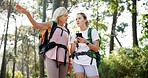 Mother, adult daughter and smartphone with hiking, lost or fitness with vacation, bonding together and network. Nature, outdoor or hiker with mother, cellphone and woods with digital app or direction