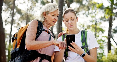 Buy stock photo Mother, adult daughter and cellphone with hiking, app or fitness with vacation, bonding together and network. Nature, outdoor or hiker with smartphone or woods with trees, travel or direction