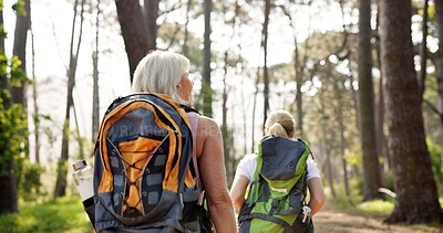 Buy stock photo Women, back and hiking with backpack in nature for travel, adventure or outdoor journey together. Female person, friends or group trekking with bag for fitness, workout or exercise in forest or woods