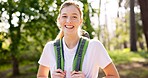Girl, portrait and hiking in nature with backpack for fitness adventure, sightseeing or explore woods. Trekking, person and happy for scenery in forest with walking, holiday travel and cardio hobby