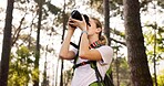 Nature, hiker and woman with camera for photography, adventure and capture memory with sightseeing. Hiking, female person and photographer for travel magazine with shooting lens, picture or equipment