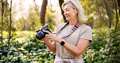 Buy stock photo Mature woman, photographer and camera in forest with smile, check and creativity for nature magazine. Journalist, photography and decision for project, research and ideas for conservation in Brazil