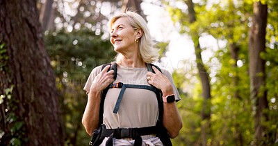 Buy stock photo Mature, woman and hiking in nature with backpack for fitness adventure, sightseeing and explore forest. Trekking, person and thinking of scenery in woods with walking, holiday travel and cardio hobby