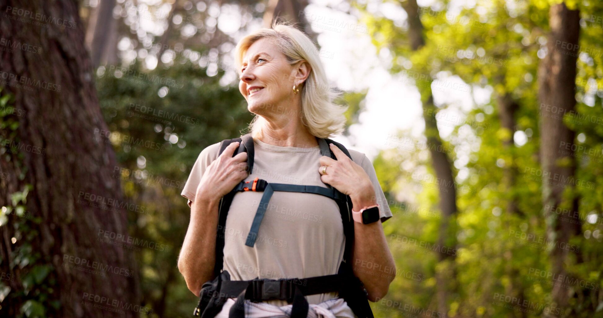 Buy stock photo Mature, woman and hiking in nature with backpack for fitness adventure, sightseeing and explore forest. Trekking, person and thinking of scenery in woods with walking, holiday travel and cardio hobby