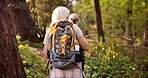 Women, hiking and forest with backpack for adventure, sightseeing or travel together in nature. Back view, female people or hikers with trees, bag or equipment for outdoor trekking journey in woods