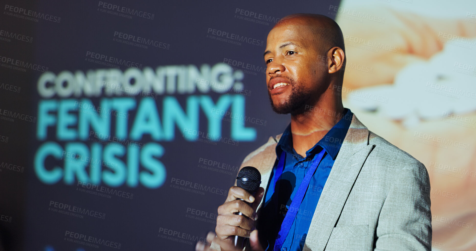 Buy stock photo Man, presentation and speech at conference for fentanyl, drugs and pharmaceutical with microphone on stage. Person, speaker and information for pills, talking and addiction crisis at convention