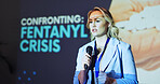 Woman, presentation and speech at conference for fentanyl, drugs and pharmaceutical with microphone on stage. Person, speaker and information for pills, talk and opioid addiction crisis at convention