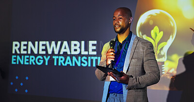 Buy stock photo Stage, presenter and black man at seminar with microphone, tablet and ideas for renewable energy. Climate change, resources and speaker at screen for conference on sustainable global power solution