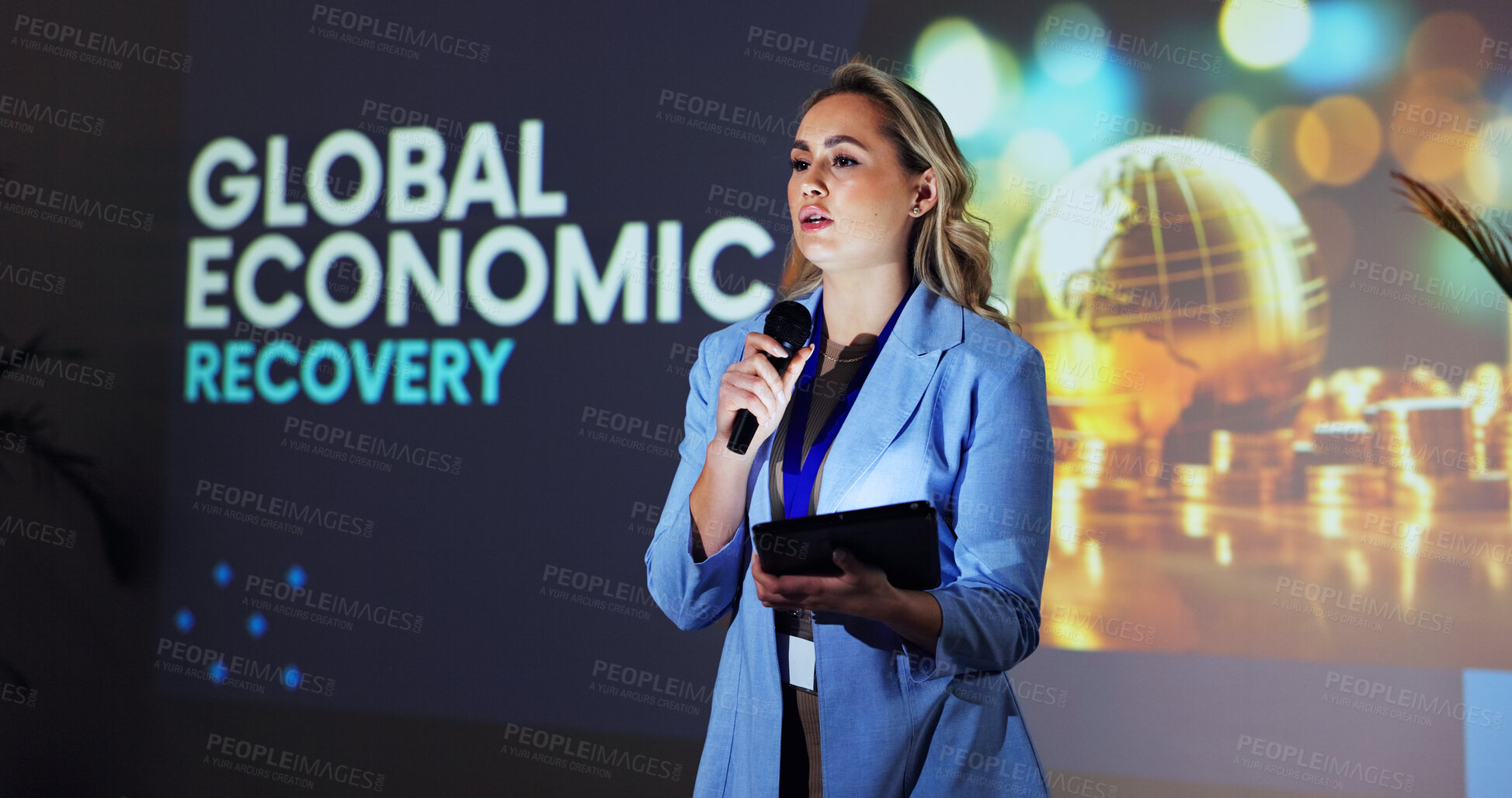 Buy stock photo Stage, speaker and woman at seminar with microphone,  tablet and global economic recovery ideas. Trade, resources and presenter at screen for conference on financial development, growth and solution