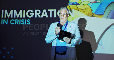 Buy stock photo Seminar, speaker and man on stage for global immigration presentation with microphone, tablet and information. Ideas, change and mature presenter at screen for international refugee crisis conference