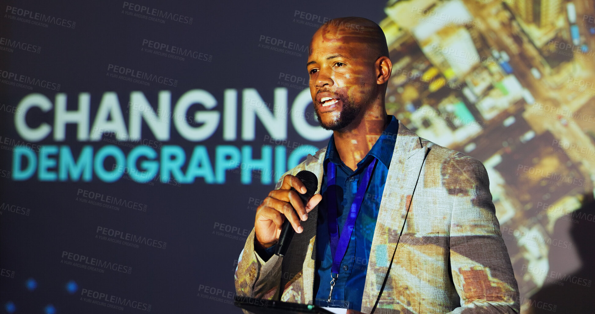 Buy stock photo Presenter, conference and black man on a stage with demographics for mortality, population growth and birth rate. Public speaking, audience and person on tablet at tradeshow, convention and seminar