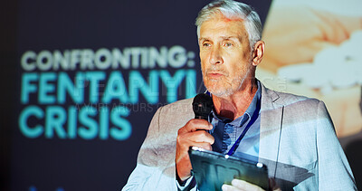 Buy stock photo Mature man, presentation and speech at convention for fentanyl, drugs and tablet with microphone on stage. Person, speaker and touchscreen with app, talking and opioid addiction crisis at conference