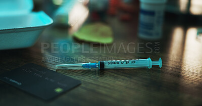 Buy stock photo Drugs, addiction and needle on table in dark apartment with opioid crisis, crime and danger. Risk, substance abuse and syringe with injection of fentanyl, narcotics or toxic habit in home at night