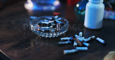 Buy stock photo Drugs, addiction and ashtray on table in dark apartment with opioid crisis, crime and danger. Risk, substance abuse and cigarette with container of pills, narcotics or toxic habit in home at night