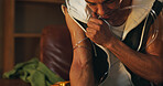 Addiction, arm and tie off with man in living room of home for drugs or substance abuse of heroin. Dark, high and vein with user person in apartment at night for compulsion, craving or dependency