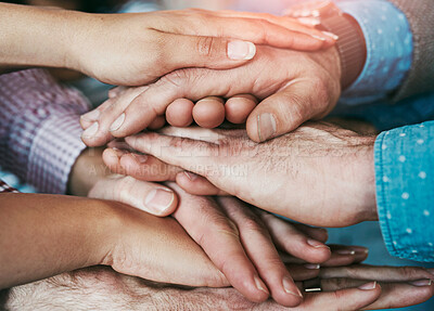 Buy stock photo Celebrating and winning business people pile of hands in victory and unity at the office. A group of employees enjoying success and victory together due to team building at the workplace