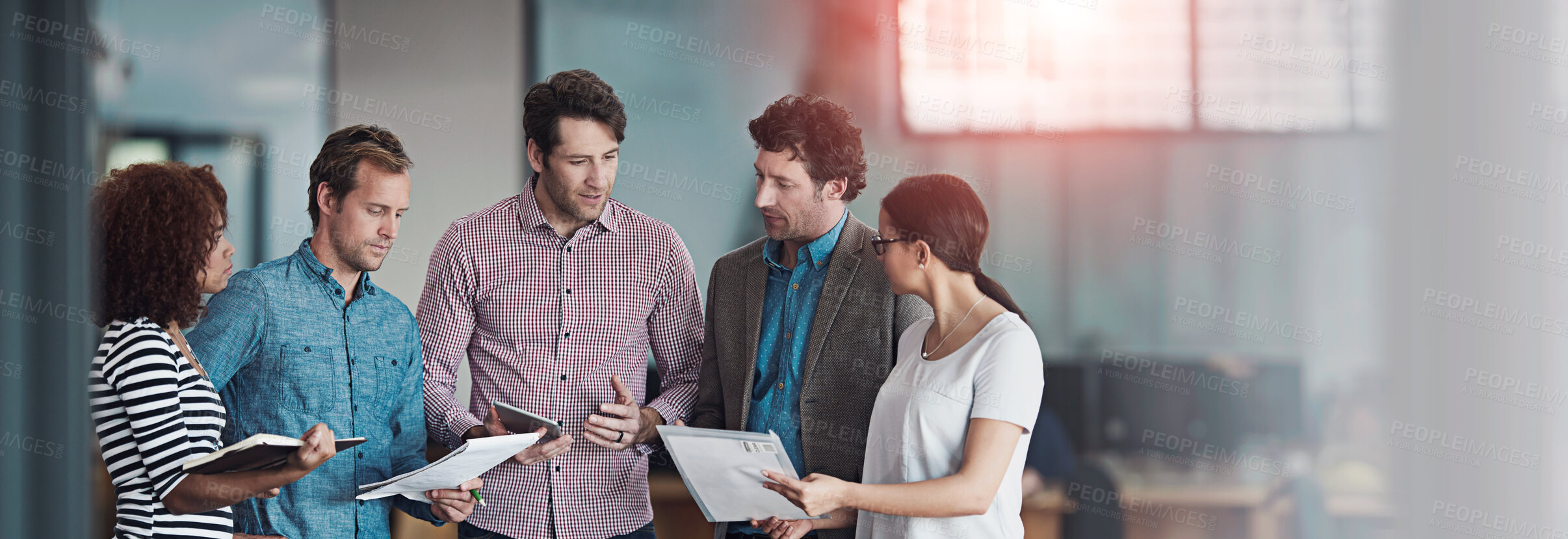 Buy stock photo Talking, planning or meeting group of colleagues brainstorming ideas, discussing strategy on paperwork and collaboating. Business man explaining reports to a diverse creative marketing team in office