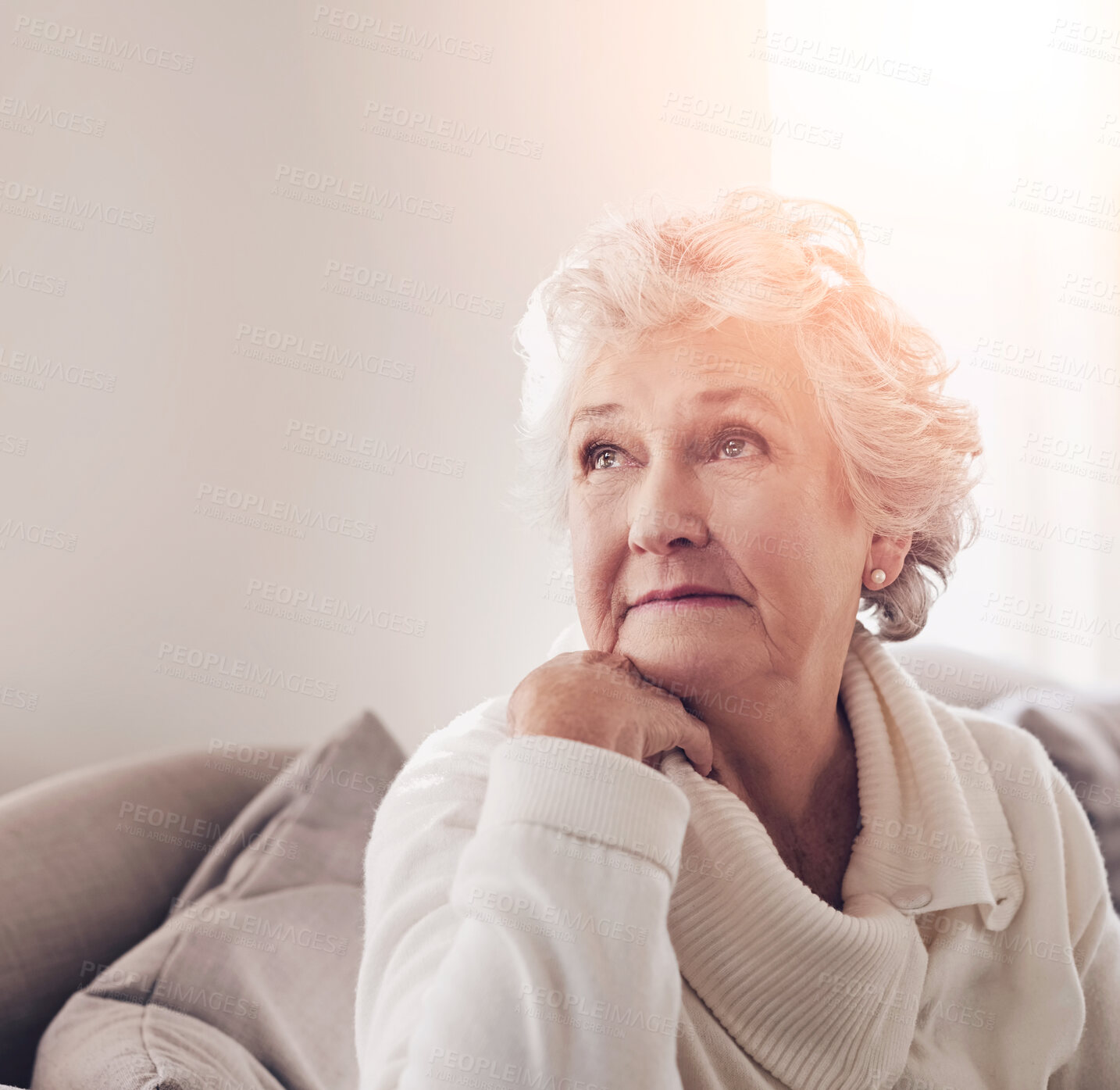 Buy stock photo Cropped shot of a senior woman looking thoughtful at home