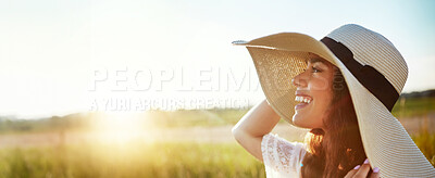 Buy stock photo Shot of an attractive young woman standing outside in a field