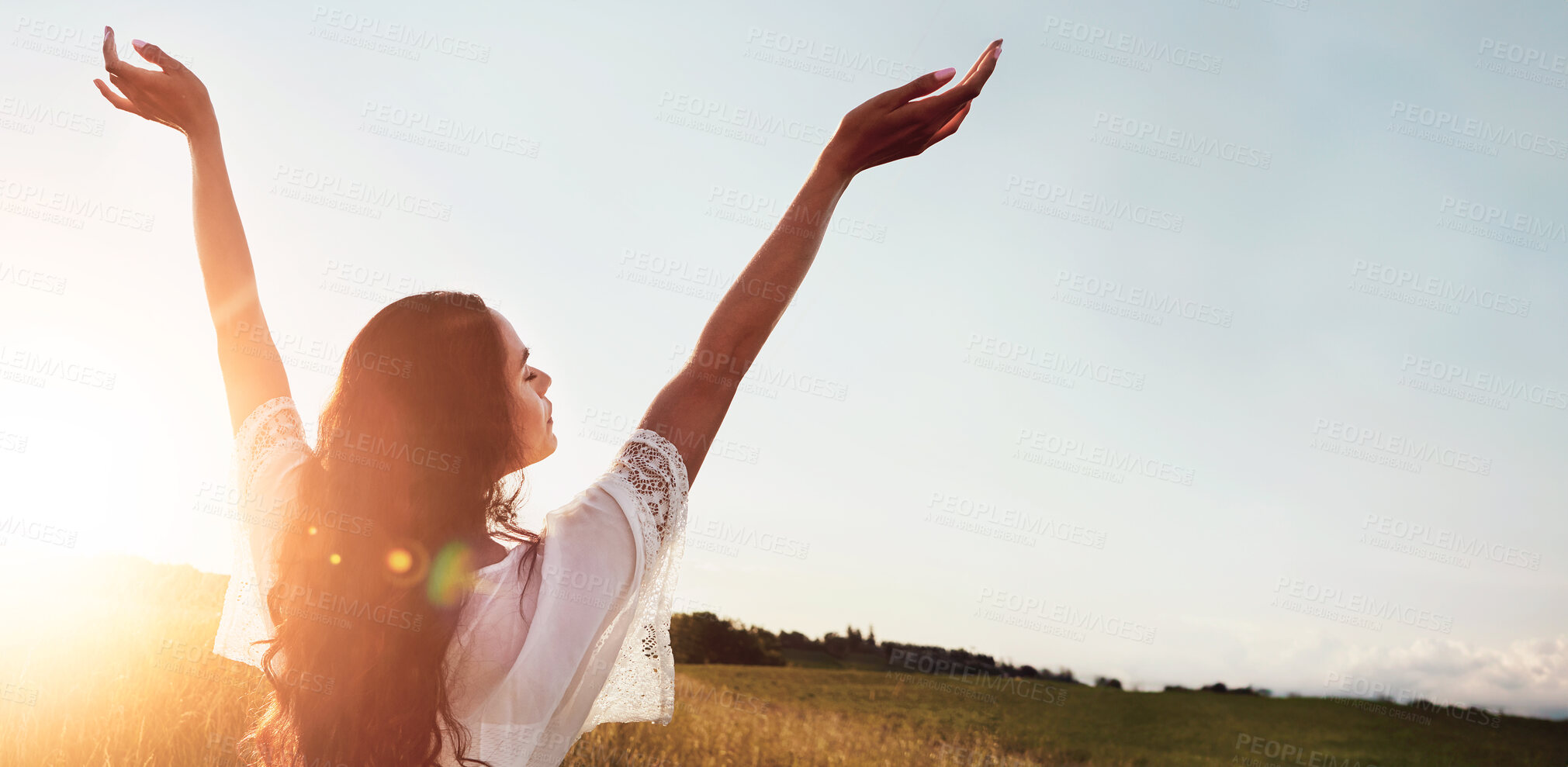 Buy stock photo Holiday, back and woman at field for freedom on adventure, calm and breathing in countryside. Arms up, meadow and person in nature on getaway trip at sunset with flare, mockup space and peace outdoor