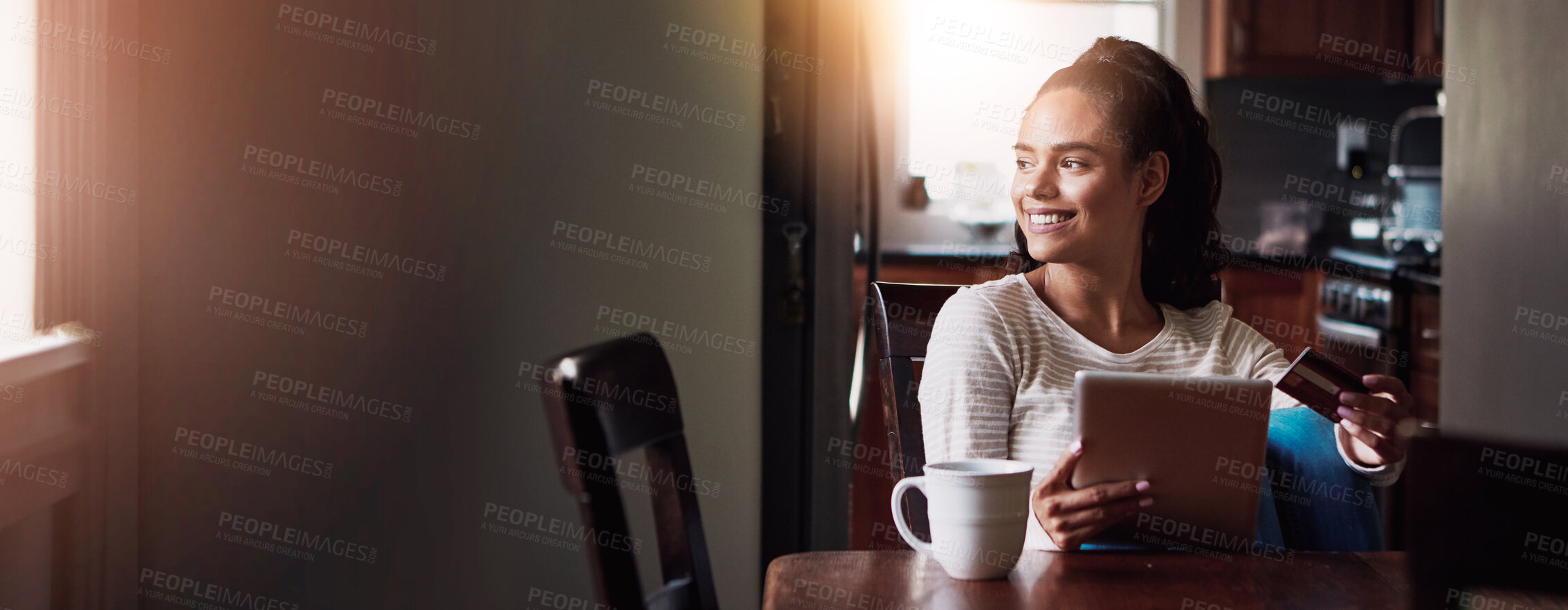 Buy stock photo Shot of a young woman drinking coffee and shopping online with her digital tablet at home