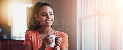 Buy stock photo Shot of a smiling young woman looking through a window while drinking a coffee at home