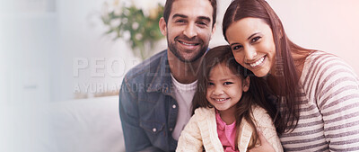 Buy stock photo Portrait of a happy young family sitting together at home