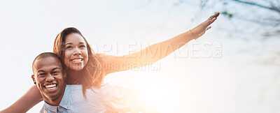 Buy stock photo Portrait of a happy young couple enjoying a piggyback ride outdoors