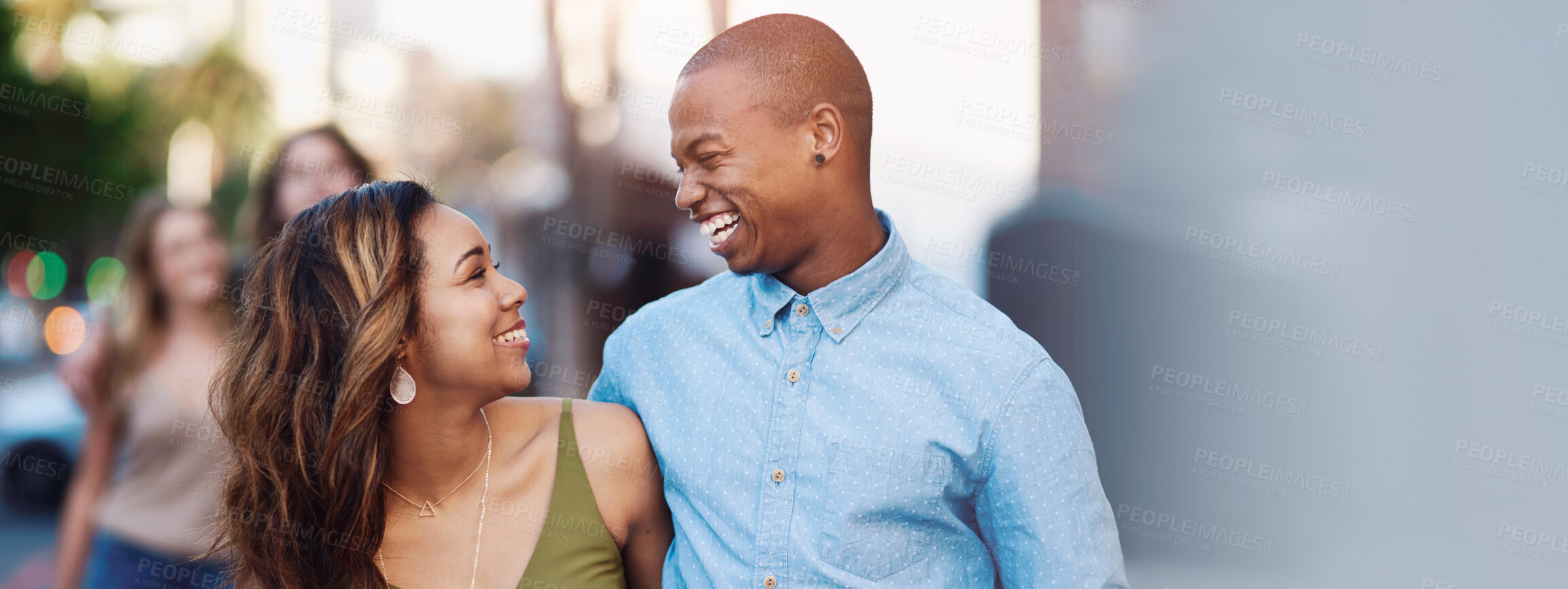 Buy stock photo Shot of two happy young couples taking a walk through the city