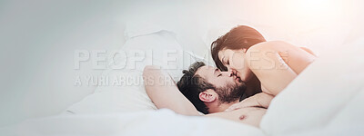 Buy stock photo Shot of an affectionate couple lying on their bed