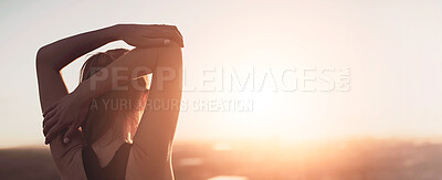 Buy stock photo Rearview shot of a sporty young woman stretching outdoors