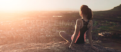 Buy stock photo Rearview shot of a sporty young woman taking in the view during a hike up the mountain