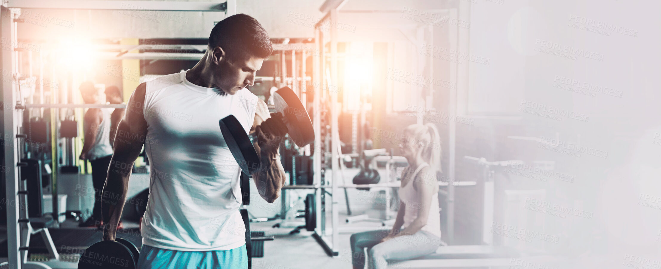 Buy stock photo Shot of a young man working out alone in the gym