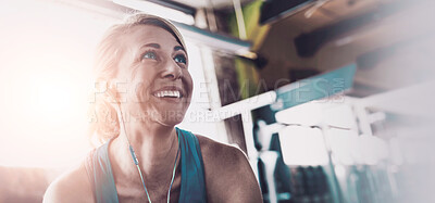 Buy stock photo Shot of a sporty woman taking a break between workouts