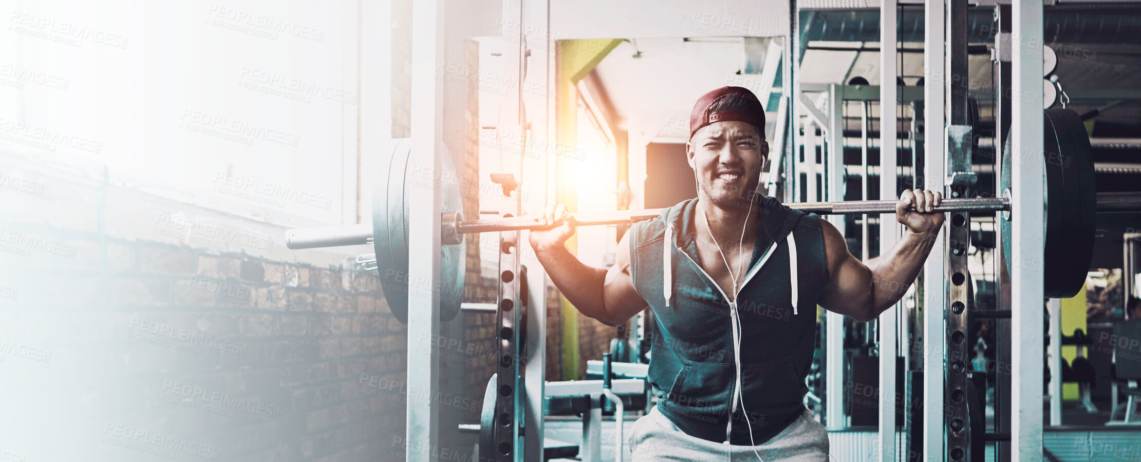 Buy stock photo Shot of a young man working out alone in the gym