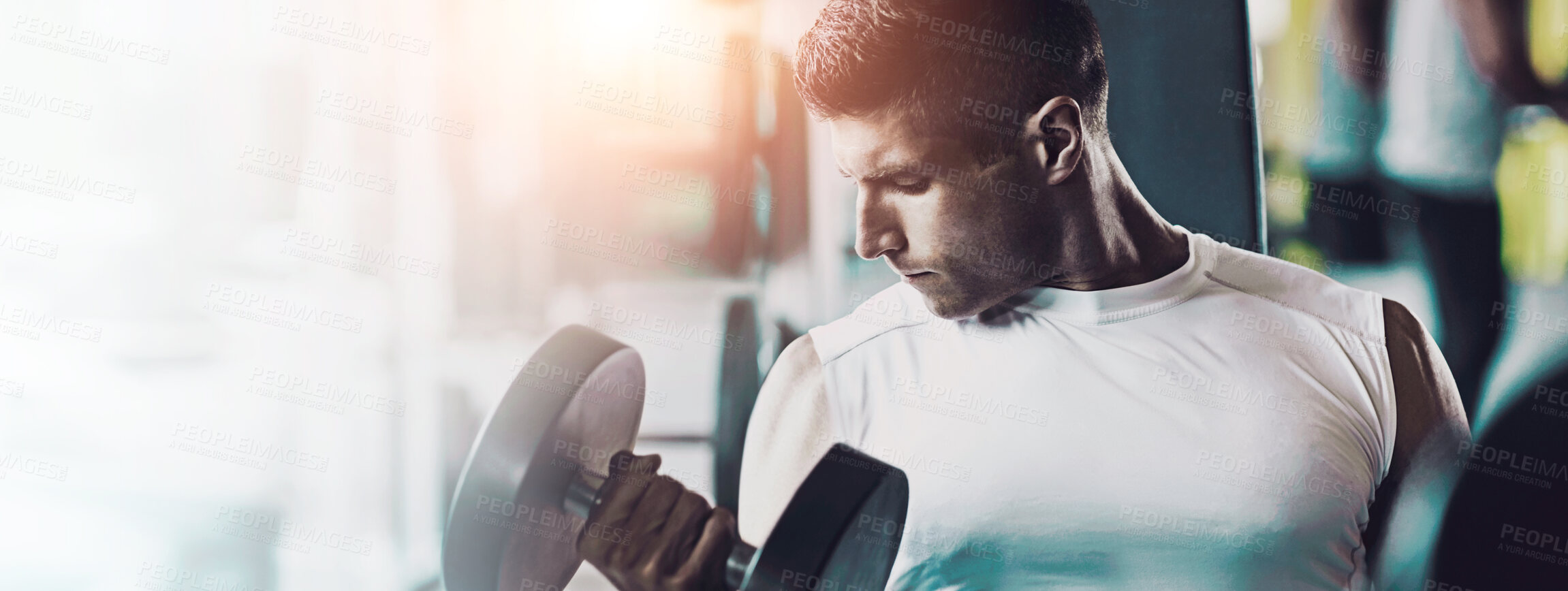 Buy stock photo Shot of a man doing a upper-body workout at the gym