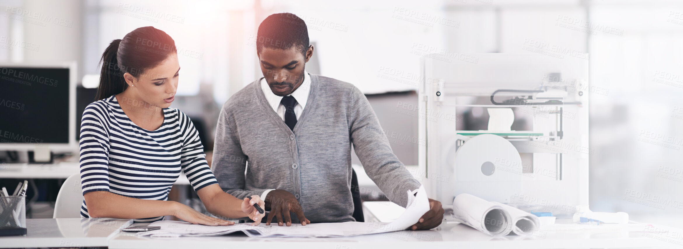 Buy stock photo Shot of colleagues working together on blueprints