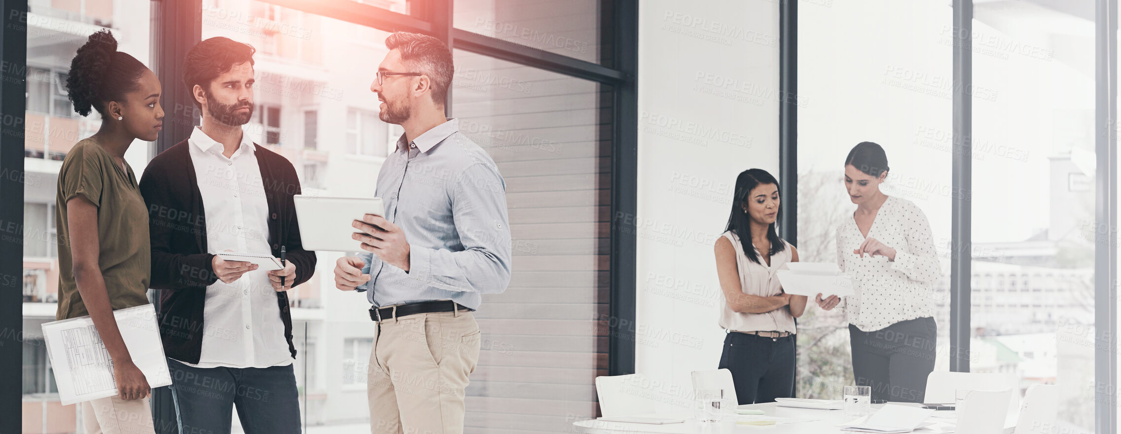 Buy stock photo Shot of a group of colleagues having a discussion in an office