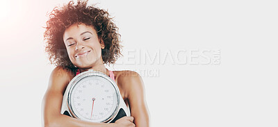 Buy stock photo Studio shot of a fit young woman embracing a scale against a white background