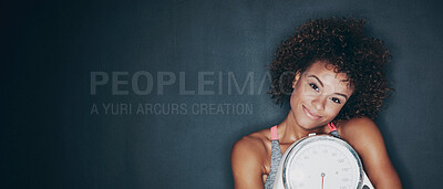 Buy stock photo Studio shot of a fit young woman embracing a scale against a grey background