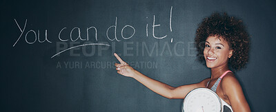 Buy stock photo Shot of a woman holding a scale against a chalk background with a motivational message